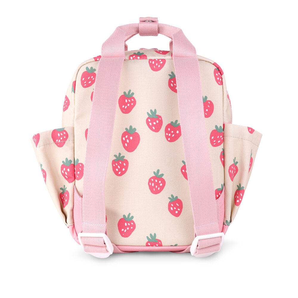 Back view of the Itzy Ritzy Sweetie Strap Plus Bear Silicone Pacifier Clip in a small beige backpack with pink straps featuring a strawberry pattern.