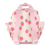 Back view of the Itzy Ritzy Sweetie Strap Plus Bear Silicone Pacifier Clip in a small beige backpack with pink straps featuring a strawberry pattern.