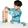 A young boy is playing with the Melissa & Doug Stack & Count Wooden Parking Garage With 10 Cars.