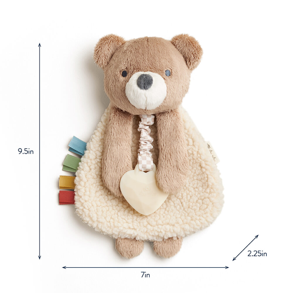 A plush bear toy with a cream-colored belly, multicolor ribbon tags on its left, and an attached beige teether at the front. Dimensions are 9.5 inches tall, 7 inches wide, and 2.25 inches deep.