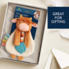 A stuffed toy packaged in a box with a "Great for Gifting" label. The toy is a plush llama with a textured teether attached.