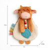 Plush cow toy with a woolly body, colorful ribbon tabs, a blue geometric teether, and size dimensions marked: 9.5 inches tall, 7 inches wide, and 2.25 inches deep.