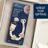 The Itzy Ritzy Sweetie Strap Plus Bear Silicone Pacifier Clip set, featuring bear-themed beads, is displayed in a box. The product tag and packaging are visible, and the text on the box reads "Great for Gifting.