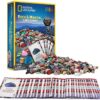 A National Geographic Rock And Mineral Card Game Gemstone BoardGame Kids Learn STEM Educational NGEO NatGeo on display, featuring playing cards and a variety of small polished rocks spread out, ideal for educating about geology and STEM.