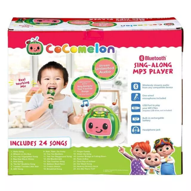 A child using a CoComelon Sing-Along MP3 Player with a real working mic. The box highlights features like Bluetooth, USB port, built-in rechargeable battery, and 24 included songs.