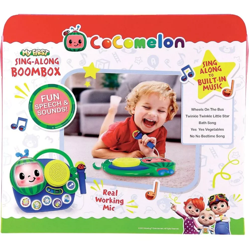 Image of a Cocomelon Toy ‘My First Sing Along Boombox’ packaging featuring a child playing with the toy. Text highlights include "Fun Speech & Sounds!", "Sing Along to Built-In Music!", and "Real Working Microphone.