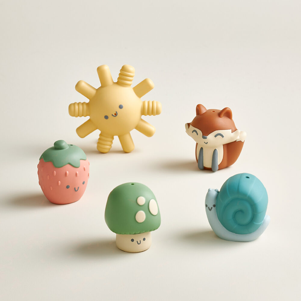 A collection of five adorable, compact figurines from the Itzy Ritzy Finger Puppets Bath Toys set: a yellow sun, a strawberry, a fox, a mushroom, and a snail.