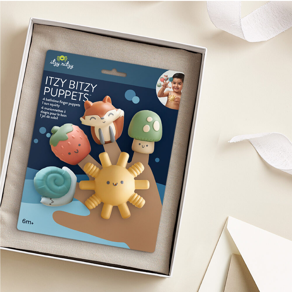 A set of five Itzy Ritzy Finger Puppets Bath Toys, featuring a fox, mushroom, strawberry, smiley sun, and turtle, displayed in packaging labeled "ITZY BITZY PUPPETS," suitable for infants aged 6 months and older.