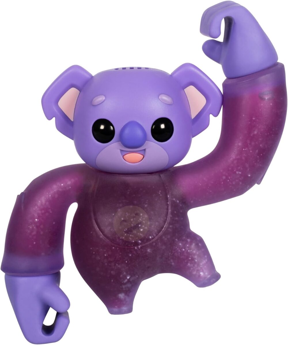 A purple, koala-like toy figure with black eyes and extended arms, posed with one arm flexed upward and the other curved downward.