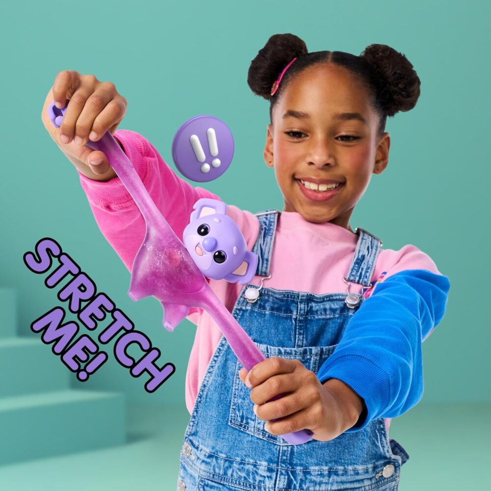 A child with two buns in her hair stretches a long, purple toy with a cute animal face and ears. The text "STRETCH ME!" is displayed on the left side. The background is light green.