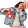 A young girl wearing a bucket hat and denim jacket holds a red toy monkey while resting her head on her hand.