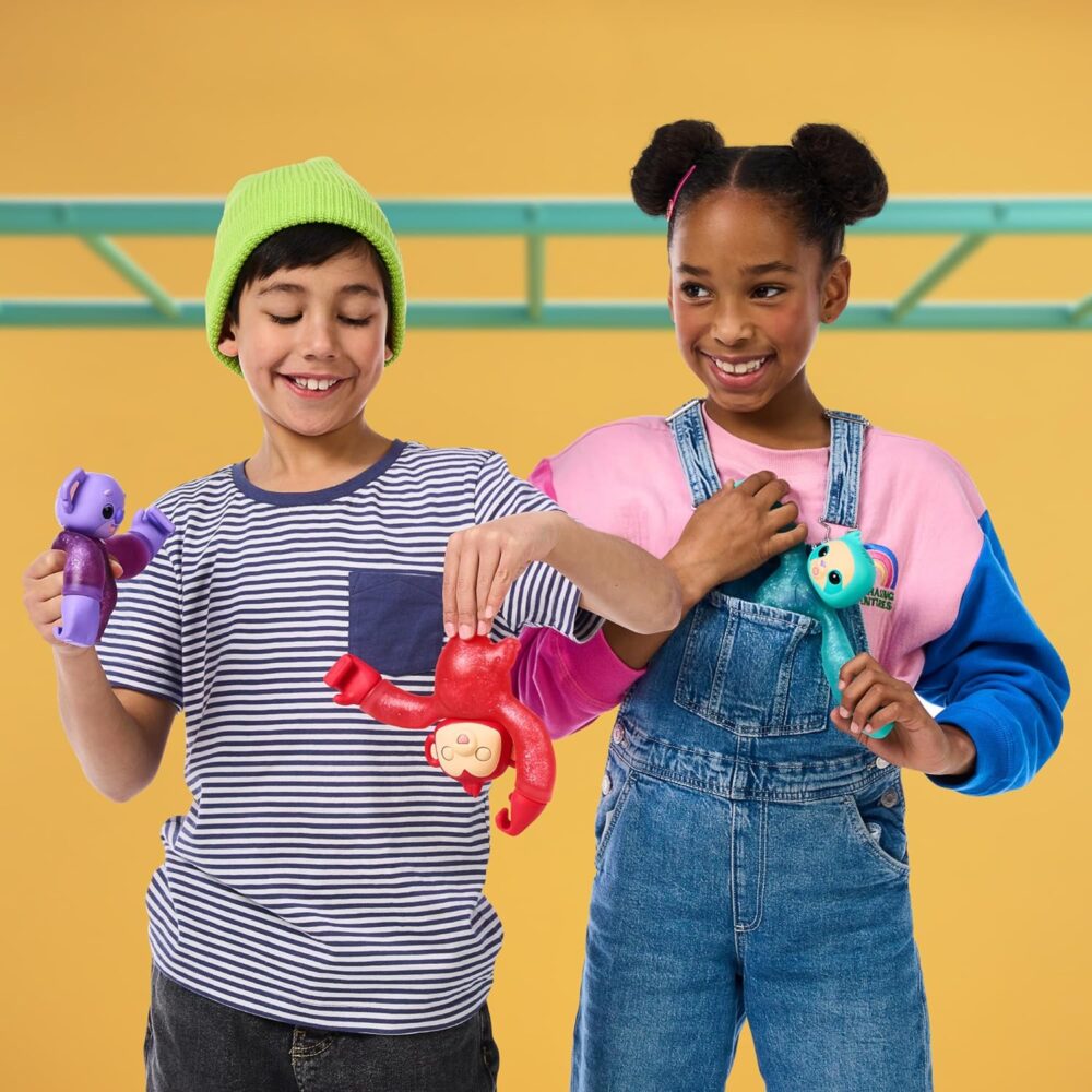 Two children play with colorful toy animals against a yellow background. The boy wears a green beanie and striped shirt, while the girl wears a pink-and-blue sweater and denim overalls.