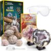 National Geographic Break Open 10 Premium Geodes featuring a pair of goggles, various geodes, a magnifying glass, a hammer, a booklet, and display stands.