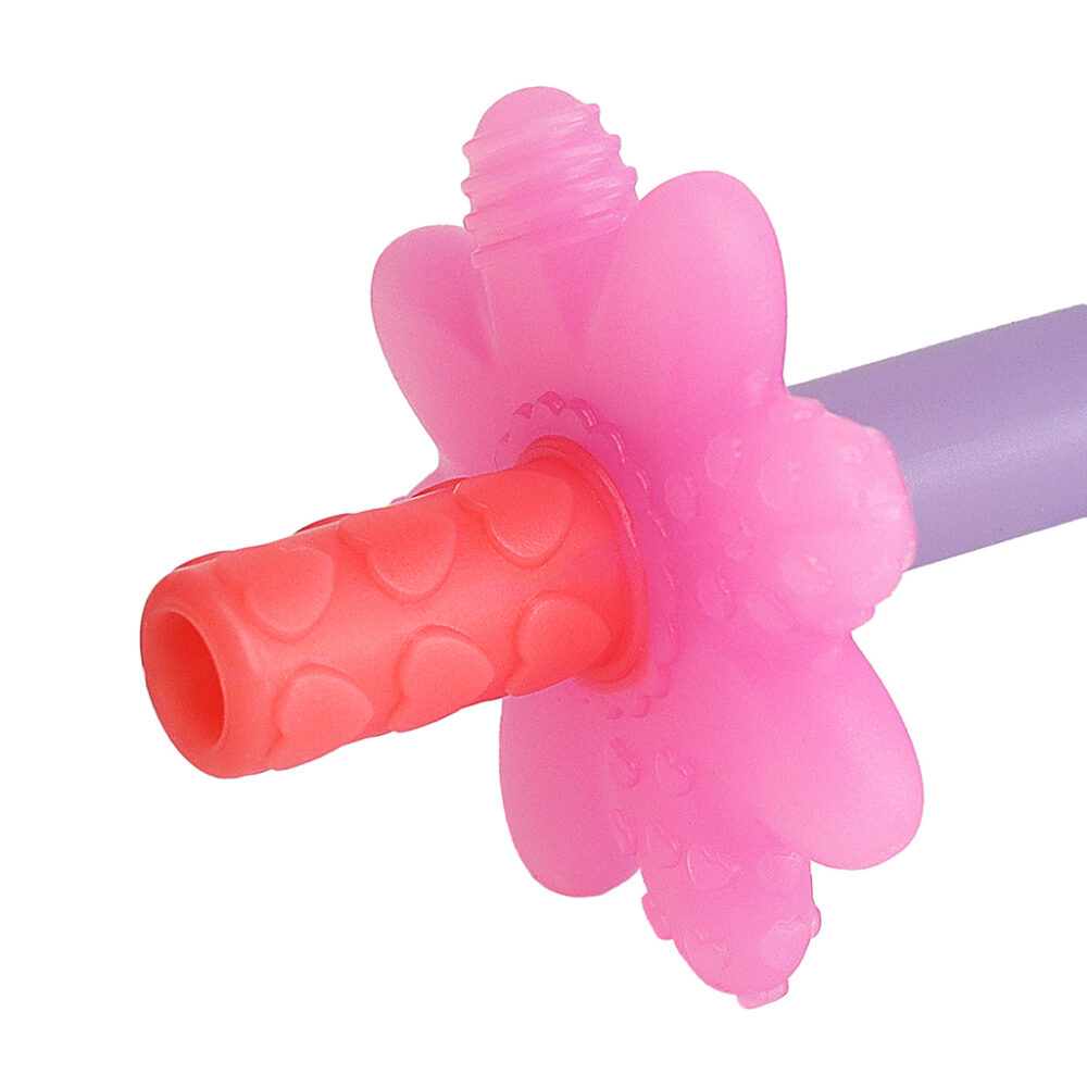 Close-up of a pink flower-shaped silicone teething toy attached to a purple handle, with a textured red tip designed for baby teething relief.