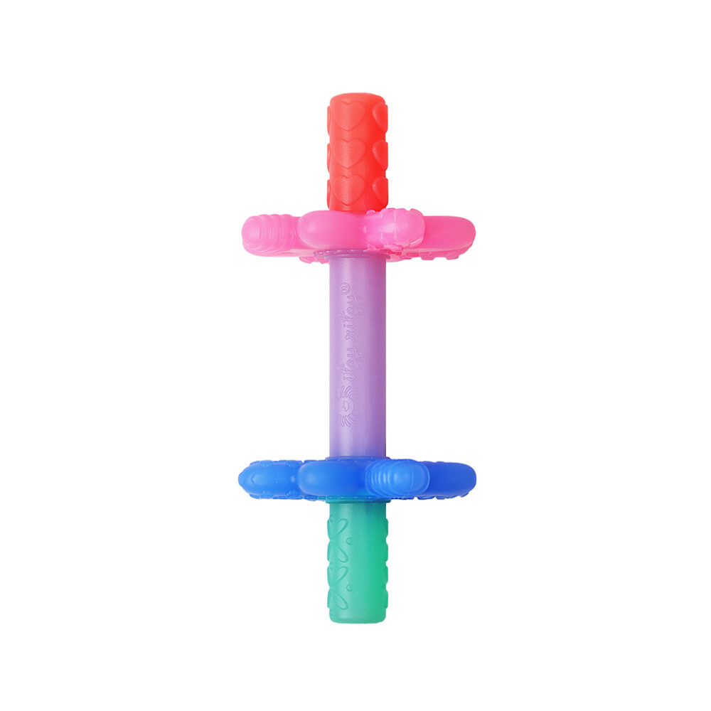 A multicolored baby teether with variously textured sections in shades of red, pink, purple, blue, and green.