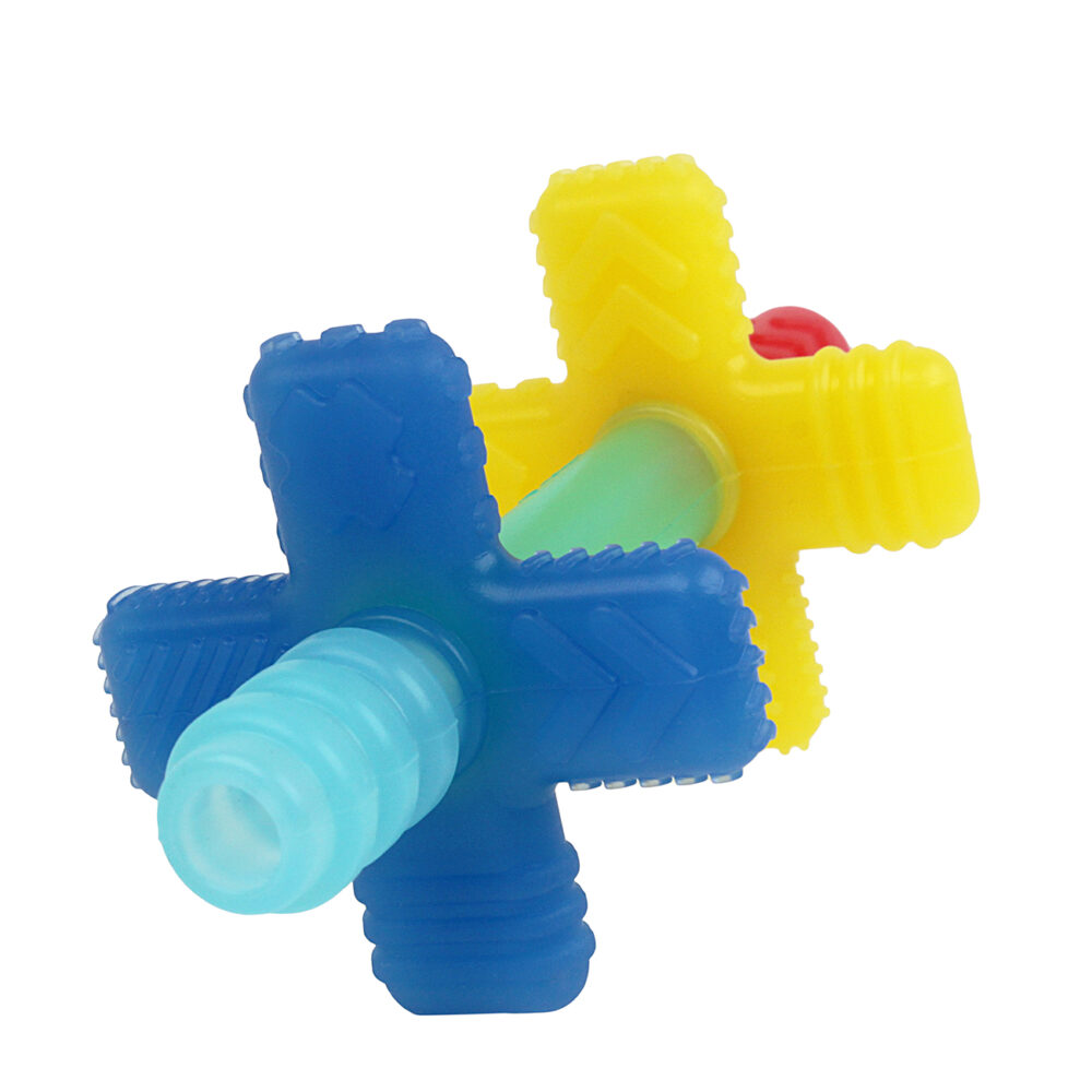 A colorful, multi-sided plastic baby teether featuring blue, yellow, and red sections with textured surfaces.