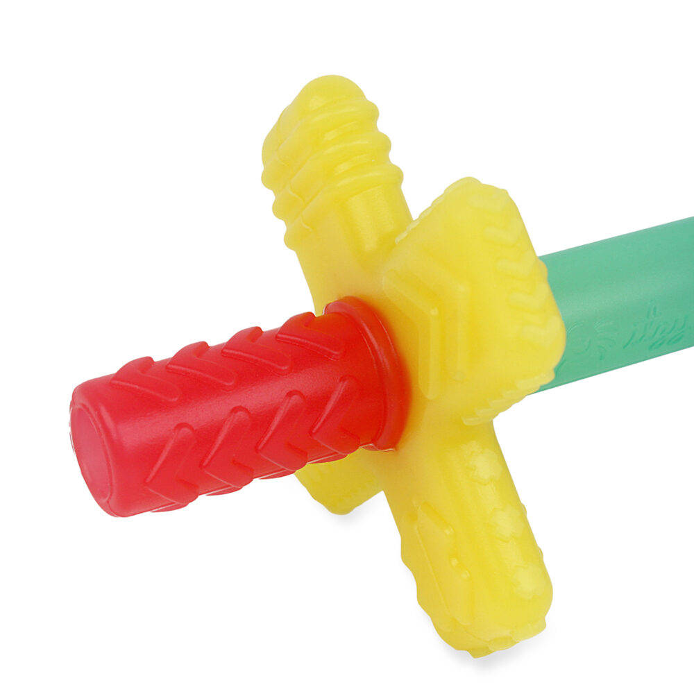 Close-up of the hilt and handle of a colorful toy sword with a red handle, yellow cross-guard, and green blade.