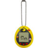 A yellow, egg-shaped digital pet device with a small screen and keychain. The screen displays pixelated characters, and the casing features graphics resembling ghosts from a classic arcade game.