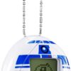 A Tamagotchi Nano x Star Wars - R2-D2 Hologram device designed to look like R2-D2 from Star Wars, featuring a pixelated image of the character on its screen and a chain for attachment.