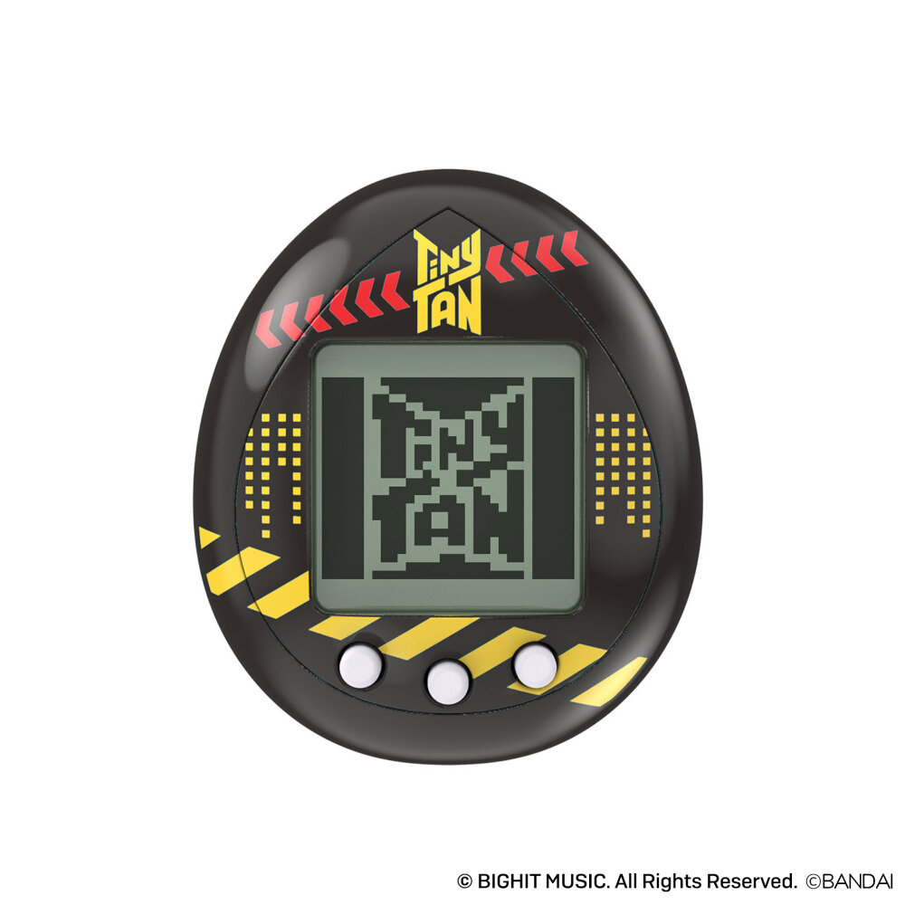 A black egg-shaped Tamagotchi device with the words "TinyTAN" on the screen, featuring three white buttons and yellow stripe accents. © BIGHIT MUSIC. All Rights Reserved. © BANDAI.