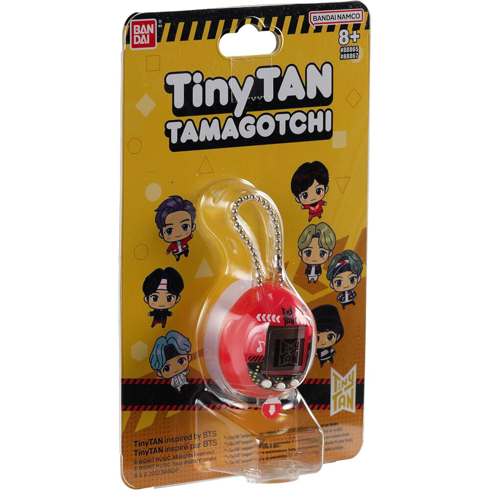 A packaged TinyTAN Tamagotchi toy featuring animated characters from the "TinyTAN" series, inspired by BTS. The packaging includes illustrations of the TinyTAN characters and is labeled for ages 8 and up.