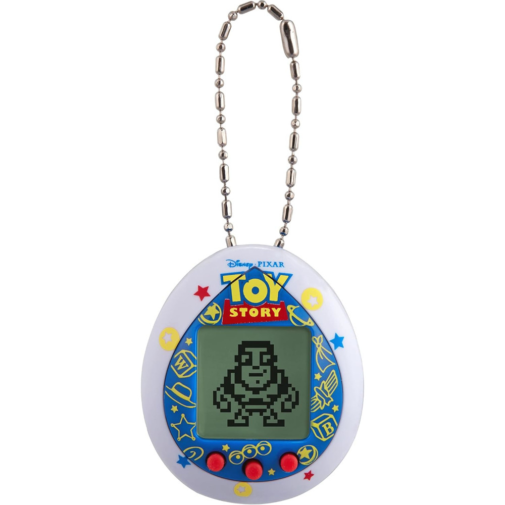 The Tamagotchi Nano x Toy Story - Friends is a Toy Story-themed virtual pet device featuring a pixelated character on the screen, a beaded chain at the top, and red buttons at the bottom.