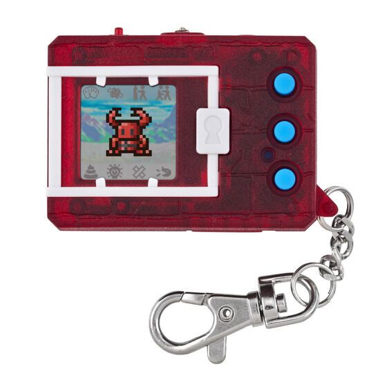 A red handheld digital pet device with a small screen displaying a pixelated character and three blue buttons beside the screen, attached to a keychain.