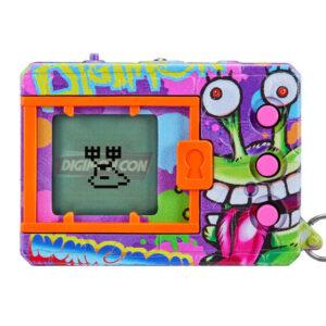 A colorful tamagotchi-like digital pet device with a graffiti design, displaying a pixelated crab on its screen. The device has pink buttons and an orange frame around the display.