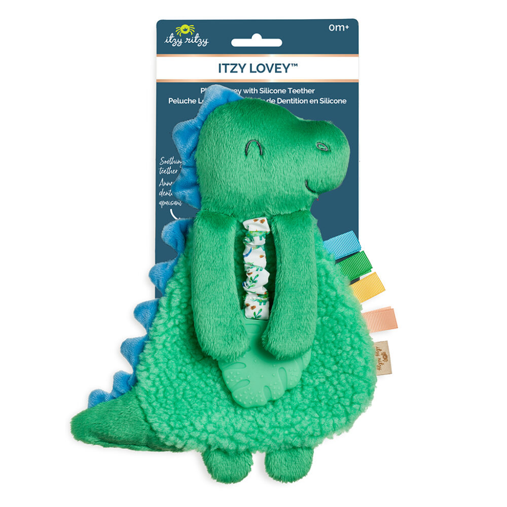 Green and blue dinosaur plush toy with silicone teether, featuring a patterned ribbon and colorful tags. The packaging is labeled "Itzy Lovey" by Itzy Ritzy, suitable for ages 0+.