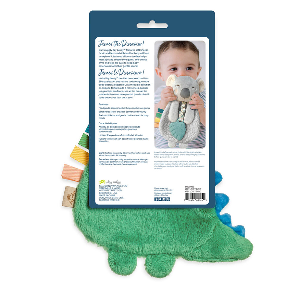 Packaging of a green plush dinosaur toy with a photo of a baby hugging the toy on the back. The text describes the toy's features, safety information, and washing instructions in multiple languages.