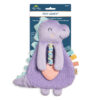 A plush dinosaur baby toy, its brand "Itzy Ritzy" visible on the packaging. The toy features a textured silicone teether and colorful ribbon tags on the side, suitable for ages 0 months and up.