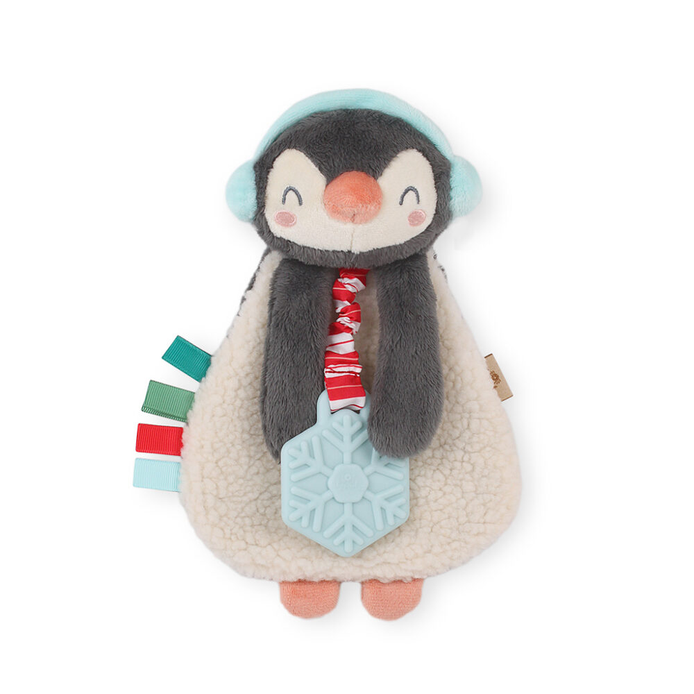 A plush penguin toy with red, green, and blue ribbon tags, wearing blue earmuffs and holding a blue snowflake teether.