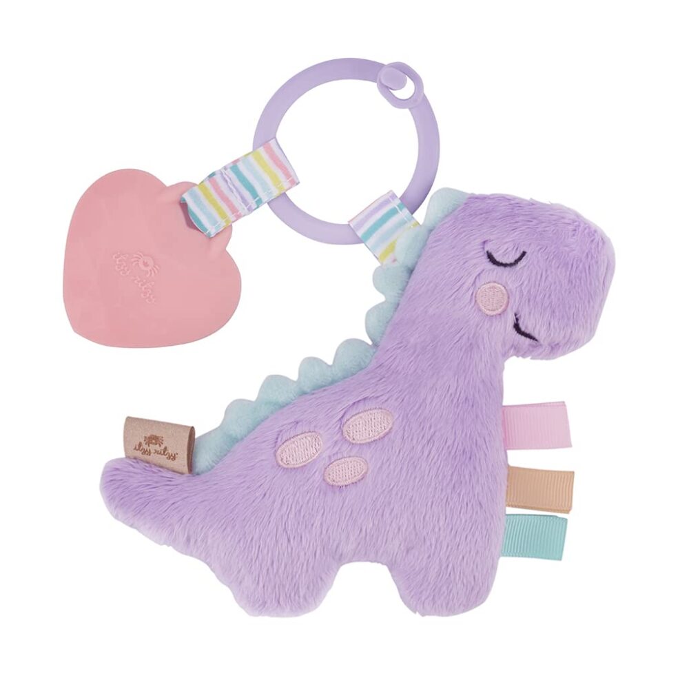 A purple dinosaur baby toy with a heart-shaped teether and colorful ribbons, isolated on a white background.