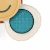 Close-up view of a baby teething toy with two ring handles. One handle is blue with a textured surface, and the other is beige with a smooth surface and a brown smiley face.