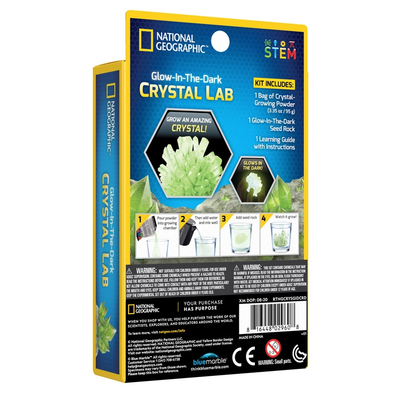 National Geographic Glow In The Dark Crystal Lab Growing Kit Educational STEM Science Boy Girl Unisex. Contains crystal-growing powder, a glow-in-the-dark seed rock, and a learning guide. Box features an image of a grown crystal, with instructions on the side.